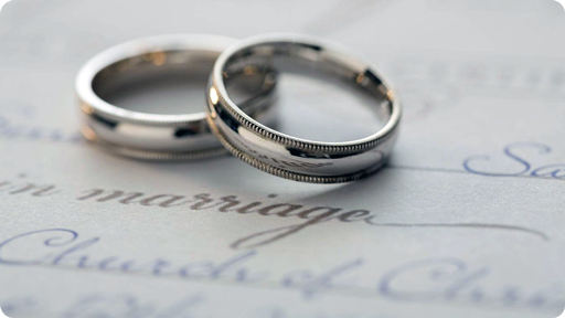 Wedding rings laying on a marriage license